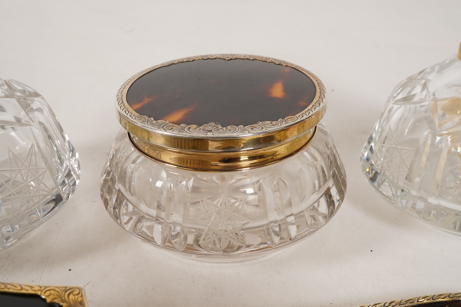 A mid 20th century continental eight piece gilt white metal and tortoiseshell mounted dressing table set